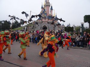 Disney characters dressed up in Halloween outfits for a parade